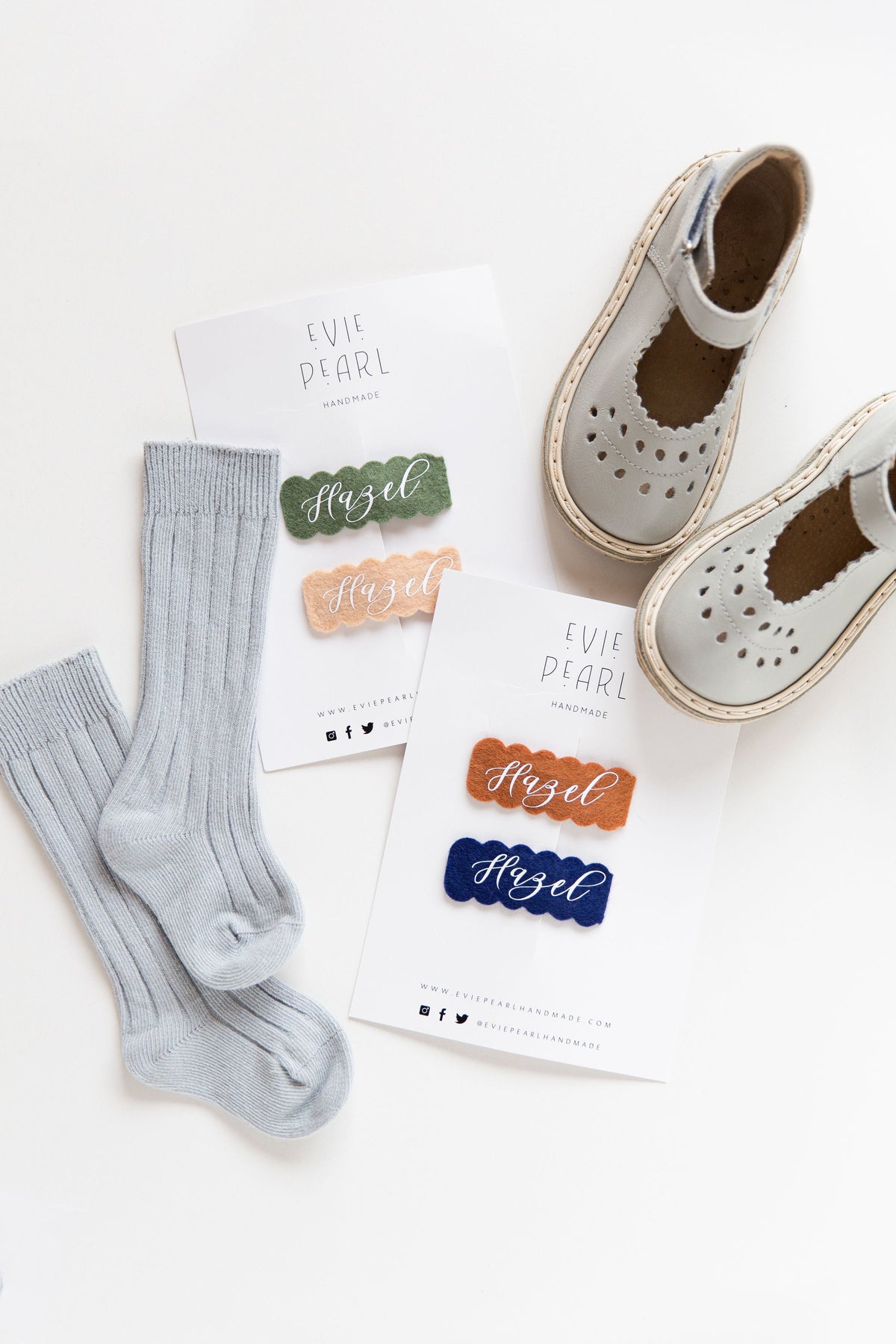 Personalized felt snap clips on cards showing the name Hazel in navy and orange