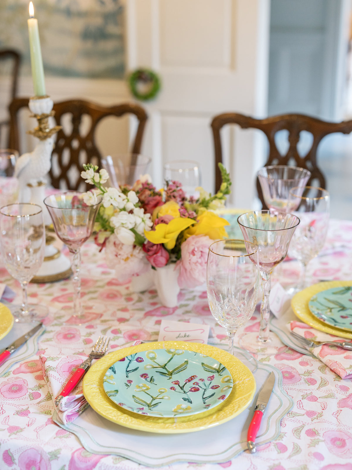 Botanical china plate with yellow rim and mint center at formal table setting