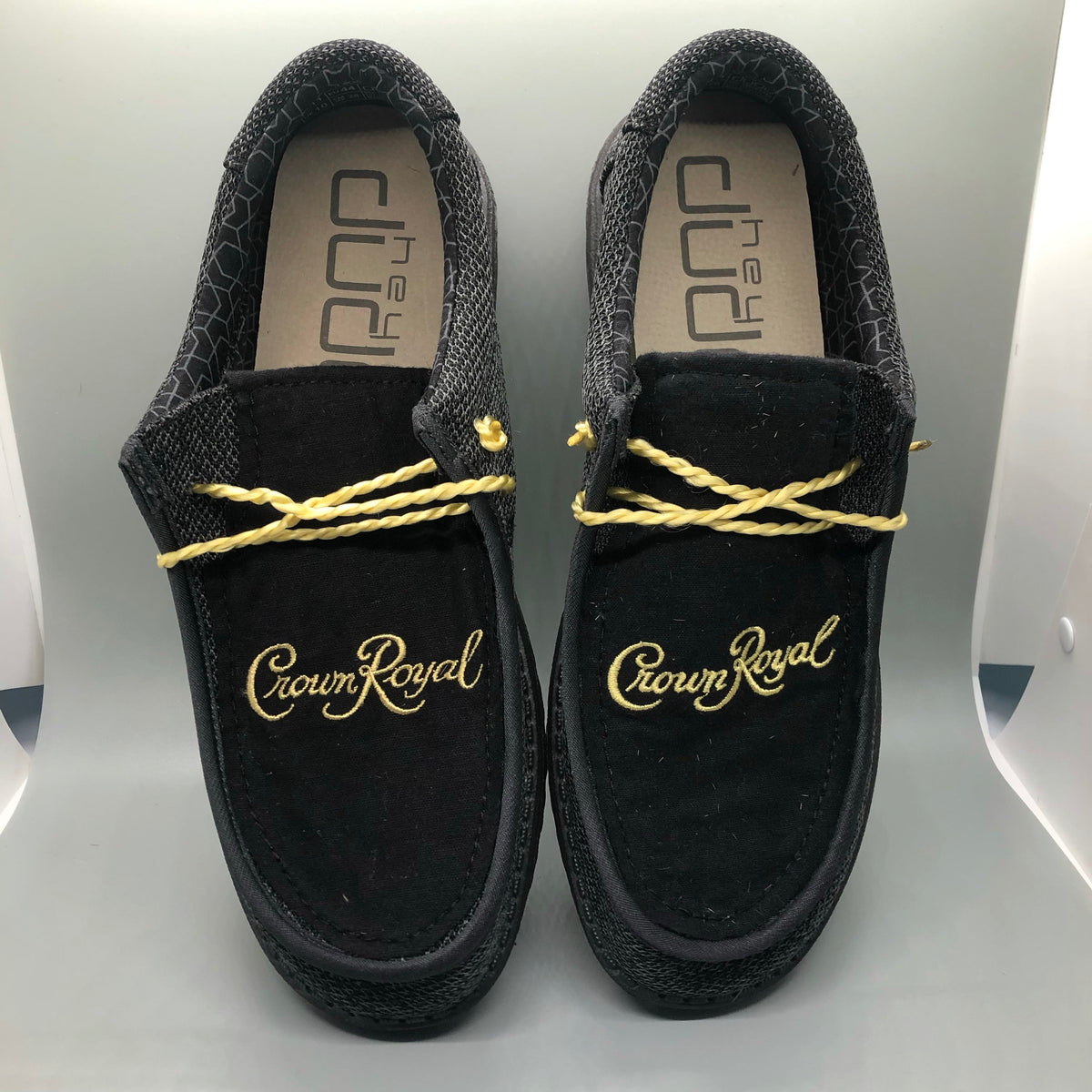 Black Crown Royal slip-on loafers with gold braided cord and logo