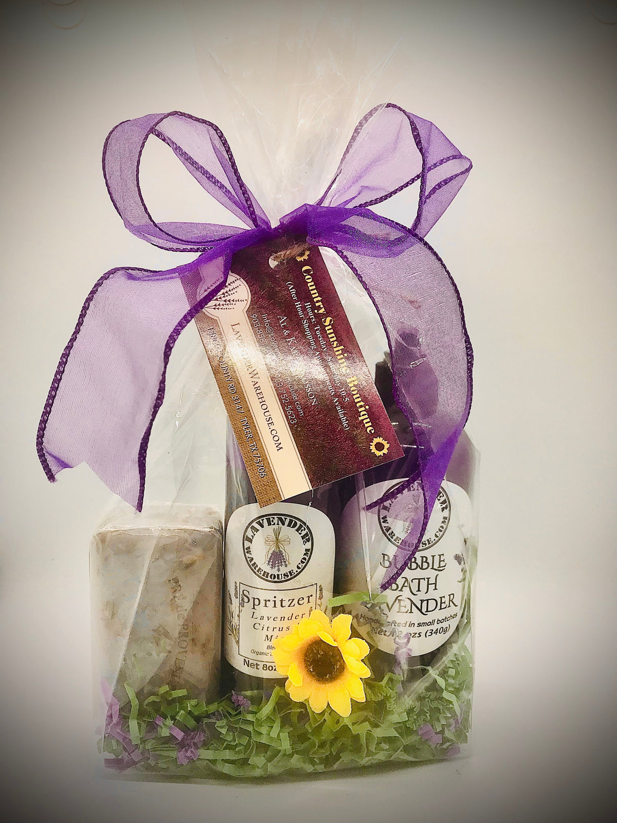 Lavender gift set in clear box with purple ribbon, soap, spritzer, and bubble bath