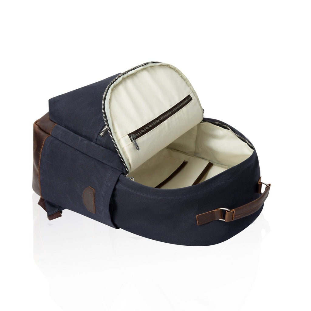Navy backpack with cream-lined interior showing zip-top compartment