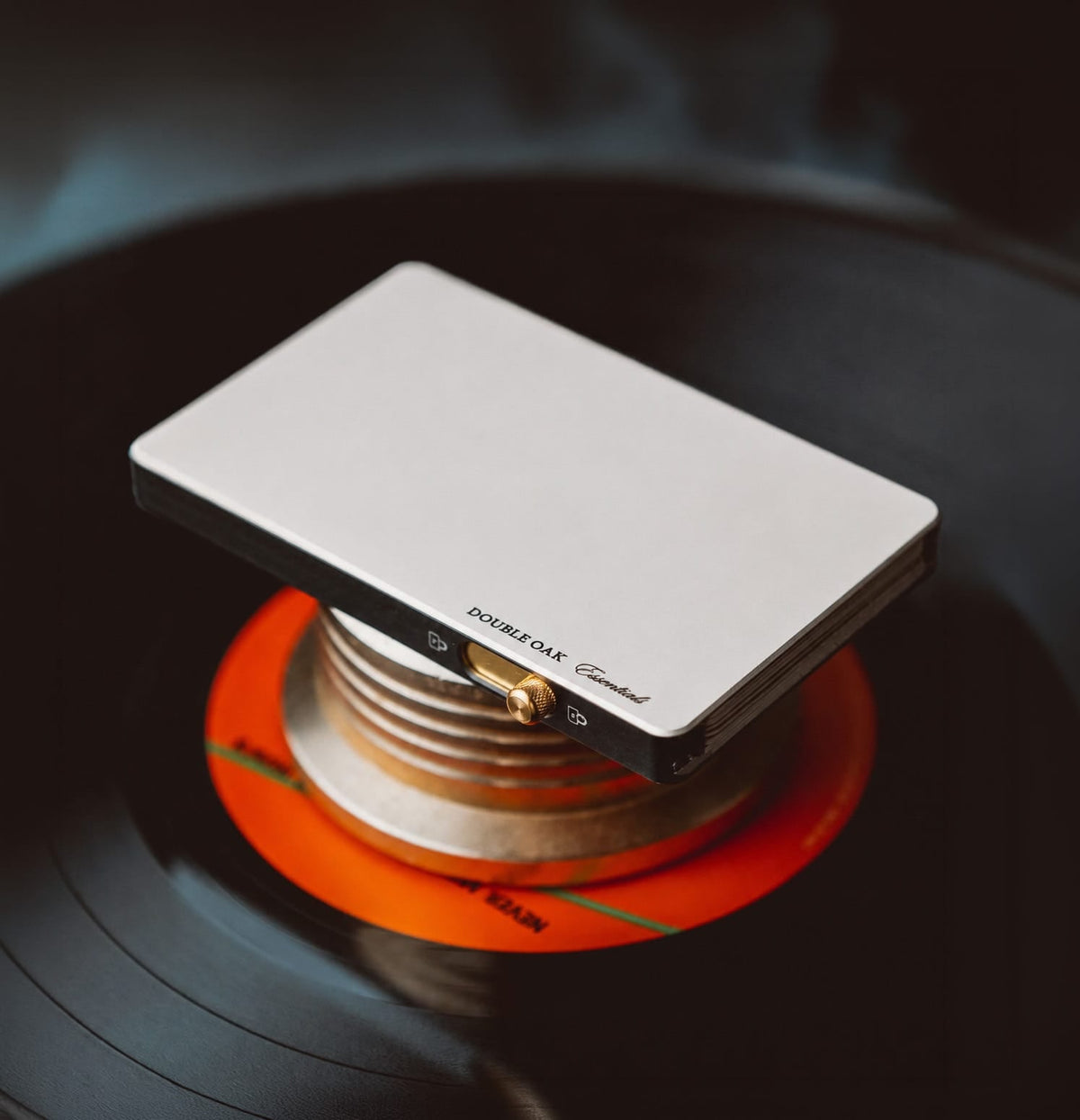 White pop-up cardholder with cards stacked, positioned over an orange base