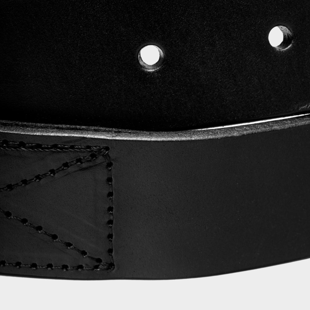 Close-up of black leather stretch belt edge with top-stitching detail