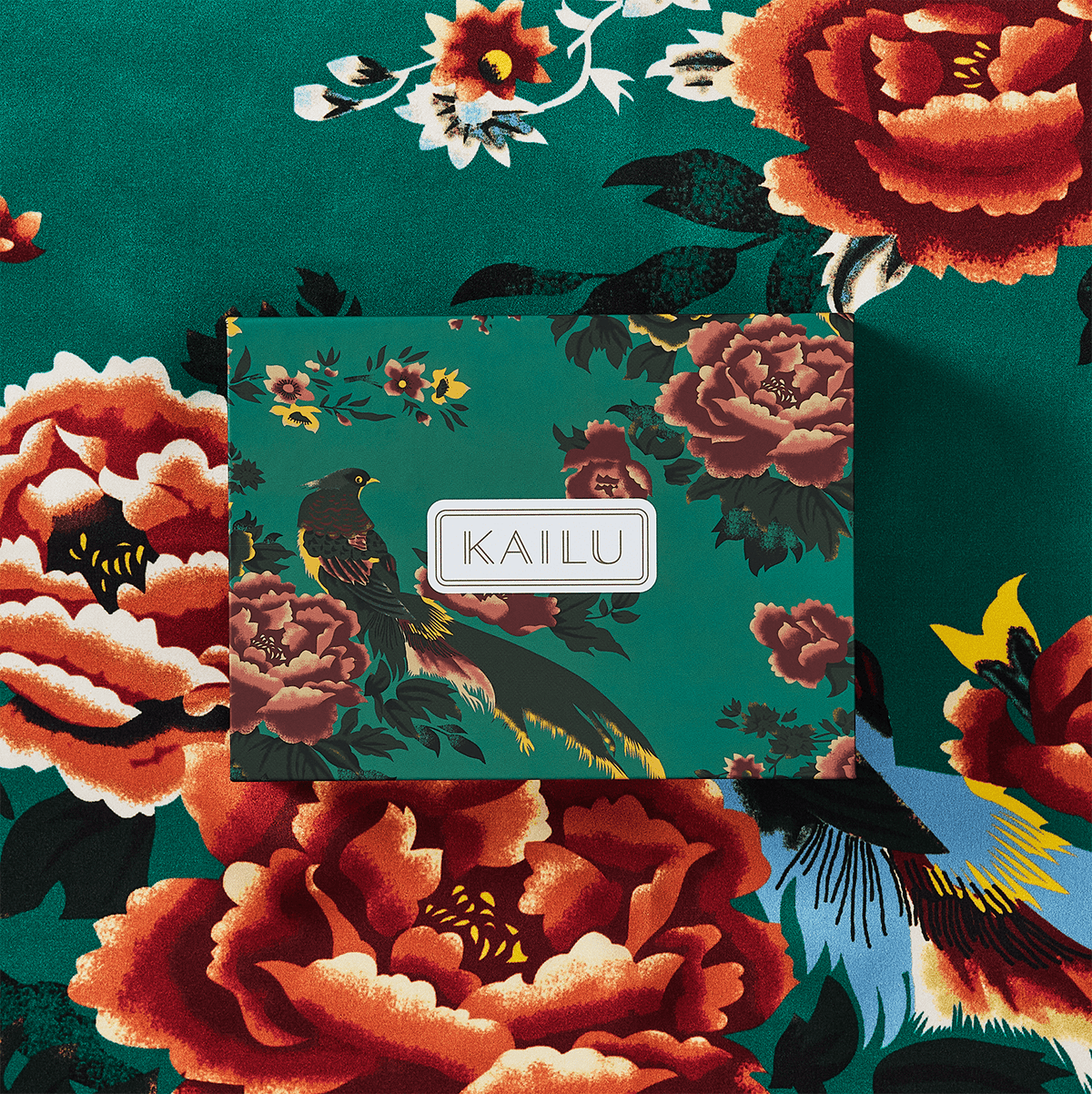 Teal silk scarf close-up of floral and bird design with KAILU label