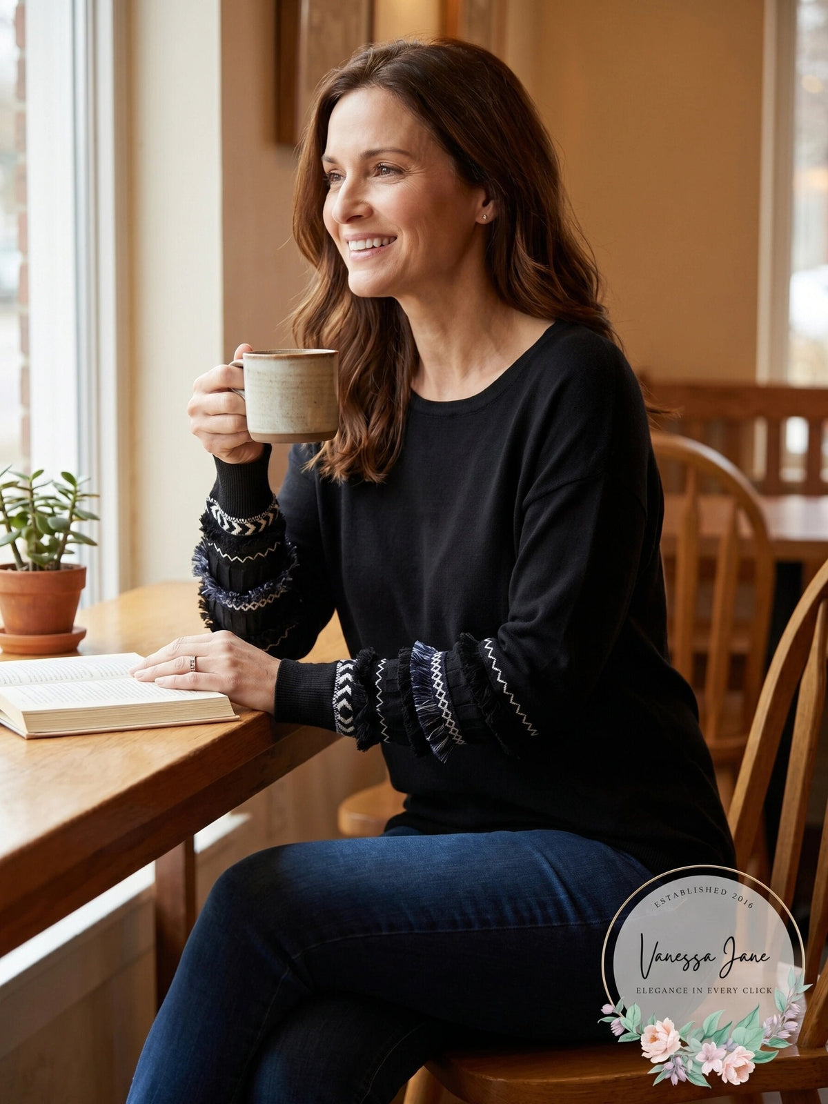 Black crew-neck knit sweater with fringe-textured band cuffs and long sleeves