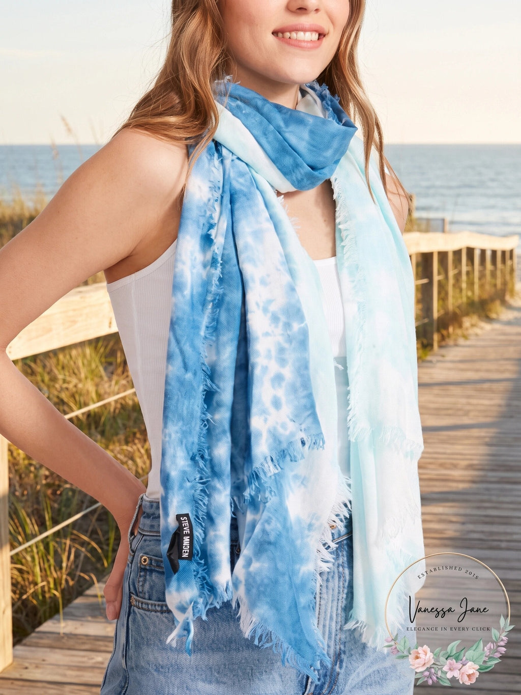 Two-tone tie-dyed scarf worn around the neck, blue and white with fringe