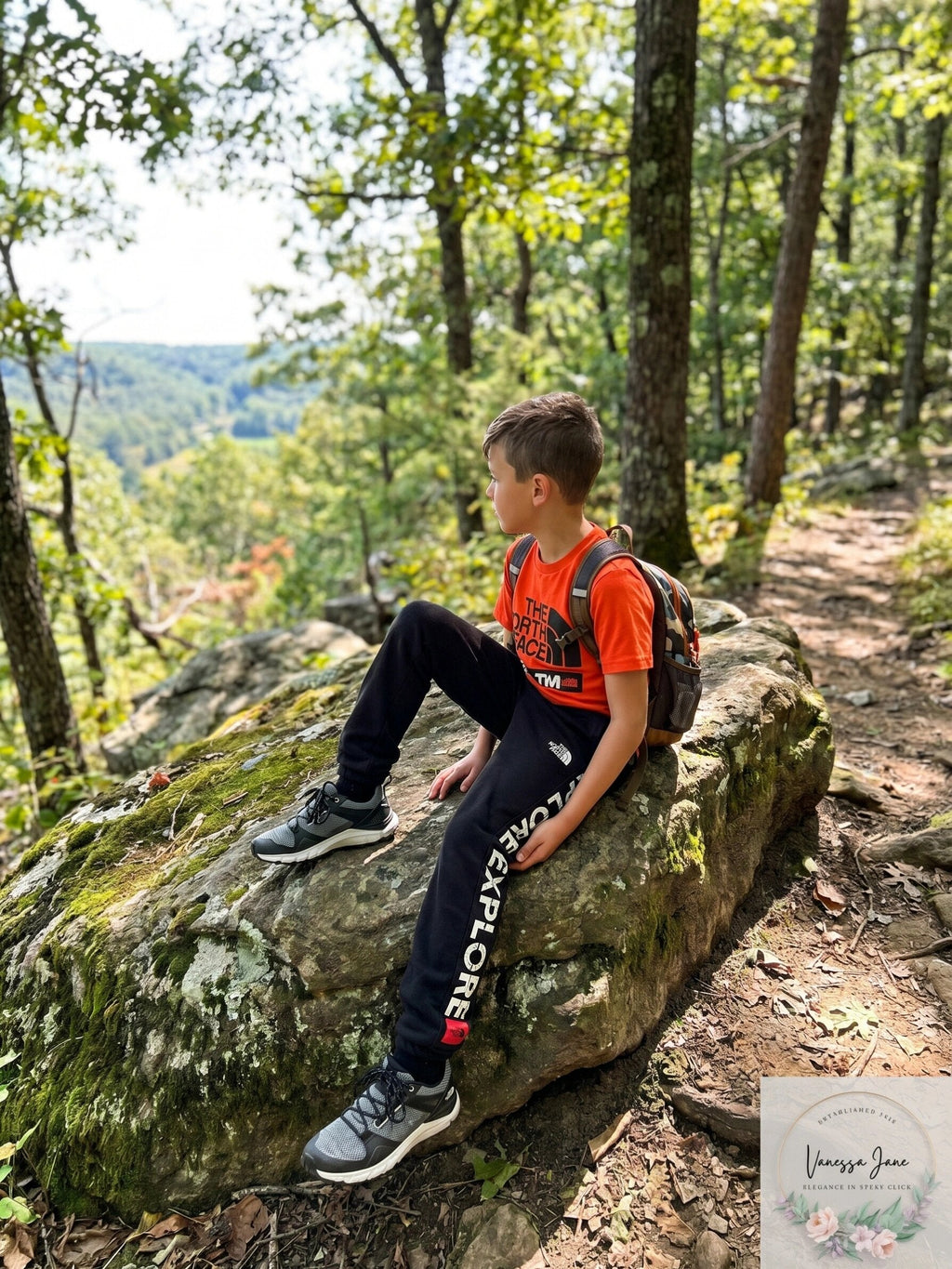Boys black fleece jogger pants with white logo print along side panels, ankle cuffs