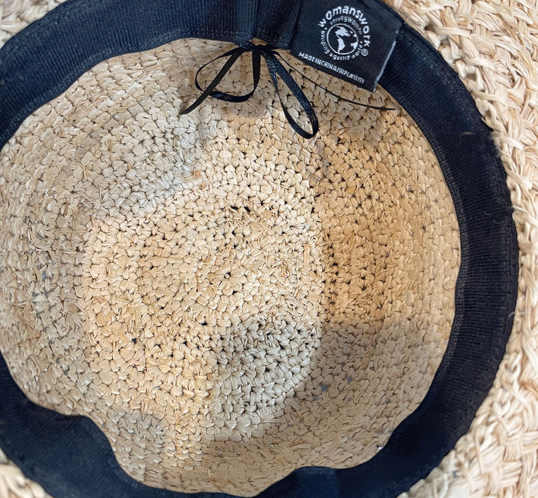 Raffia sun hat interior with navy band and brand patch