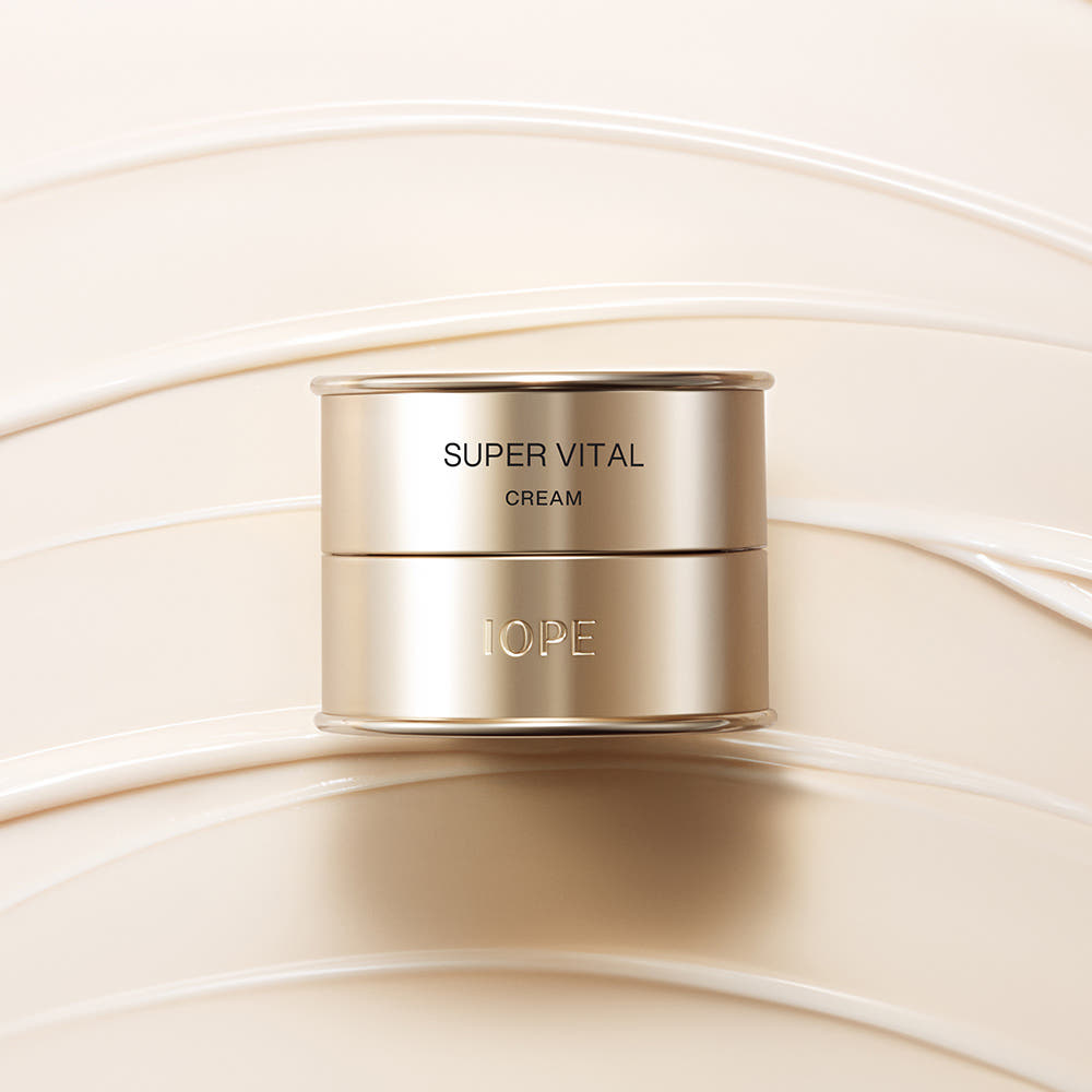 IOPE Super Vital cream jar with gold lid and label on pale cream swirls.