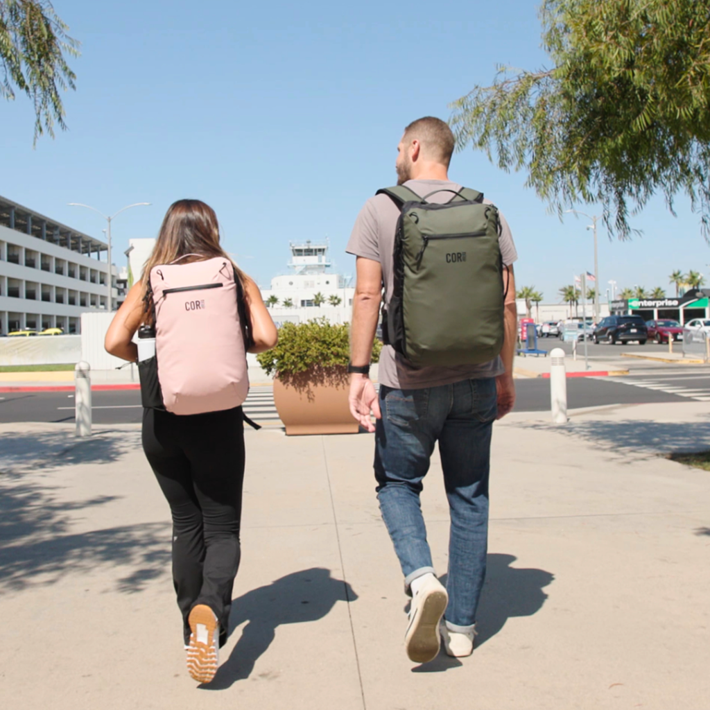 28L travel backpack worn on back, pink main bag with top handle and zip front pocket