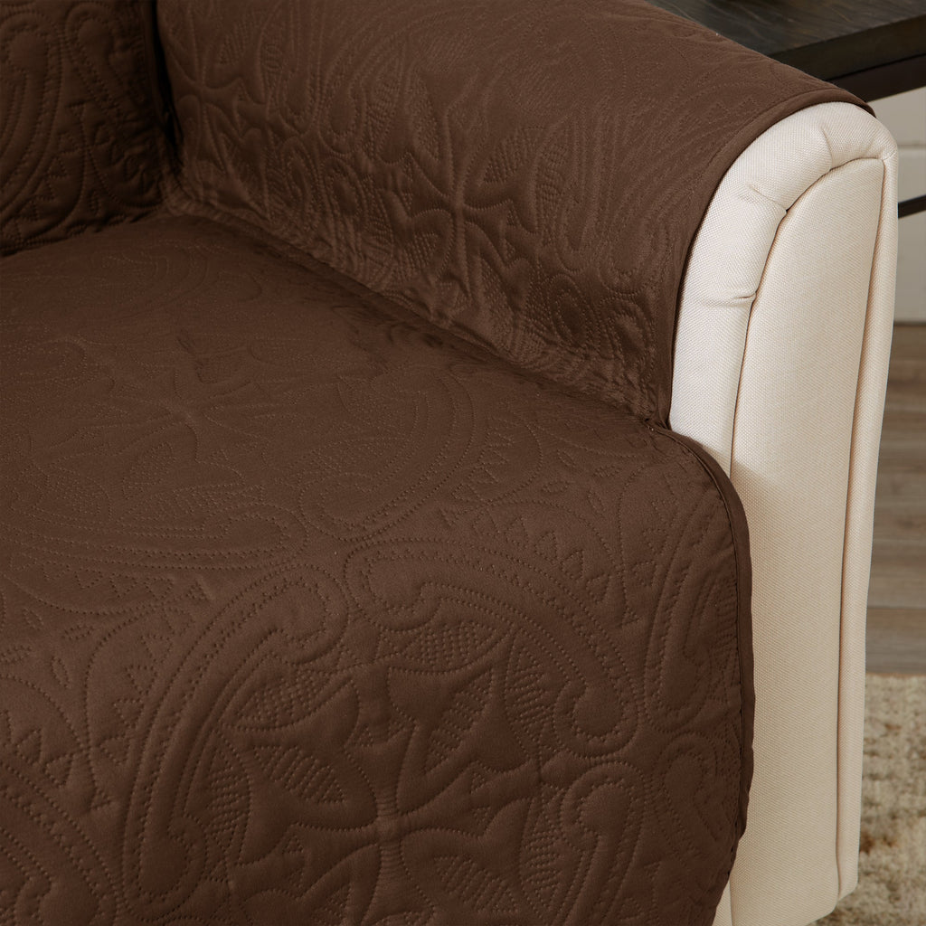 Brown recliner protector with quilted medallion pattern and beige arm panel trim