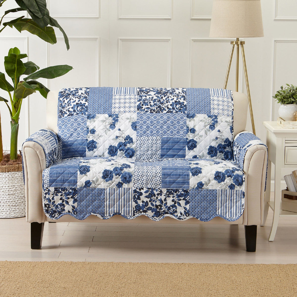 Quilted patchwork loveseat protector in blue and white with floral and striped details