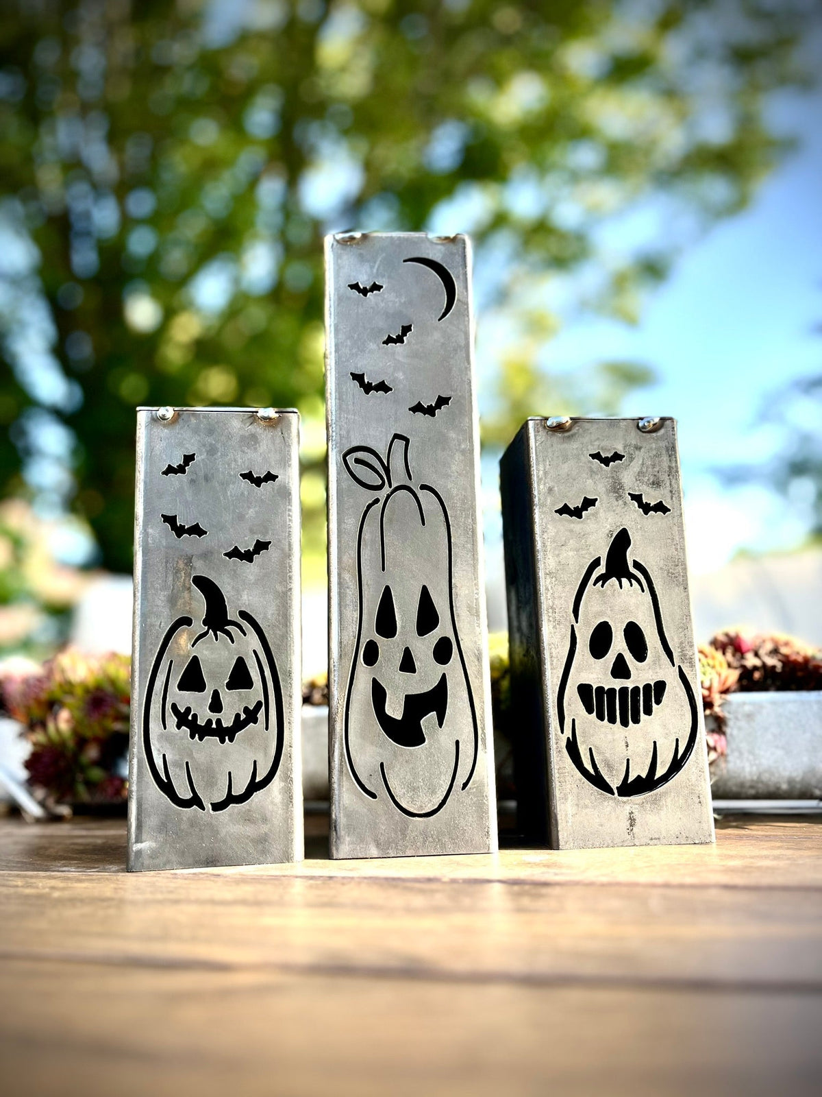 Steel solar tube lights with carved jack-o-lantern and bat cutout panels