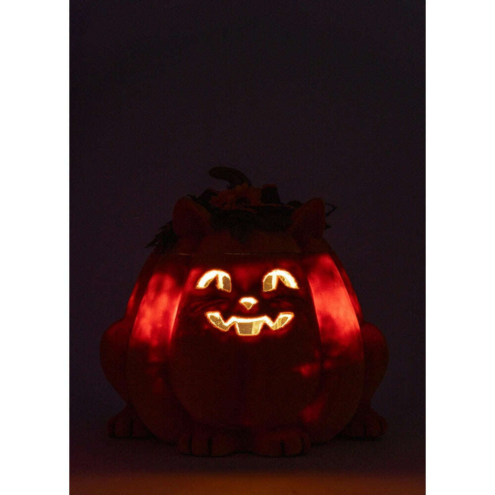 Lit orange plush pumpkin cat candy container with glowing jack-o-lantern eyes and grin