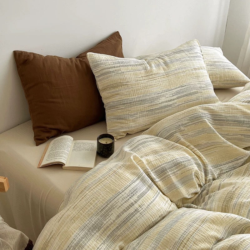 Textured duvet cover set with beige and brown stripe pillows and matching duvet cover