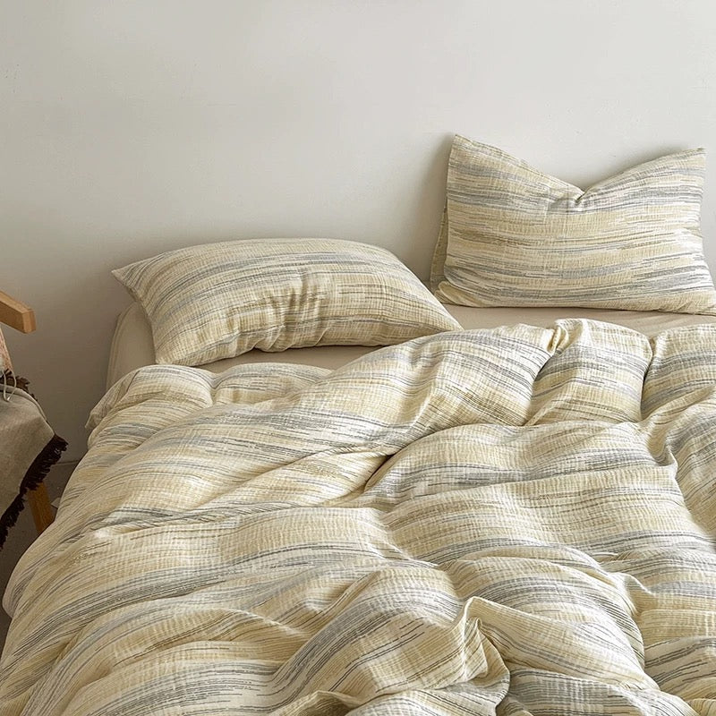Textured duvet cover set with light cream stripe duvet and matching square throw pillows