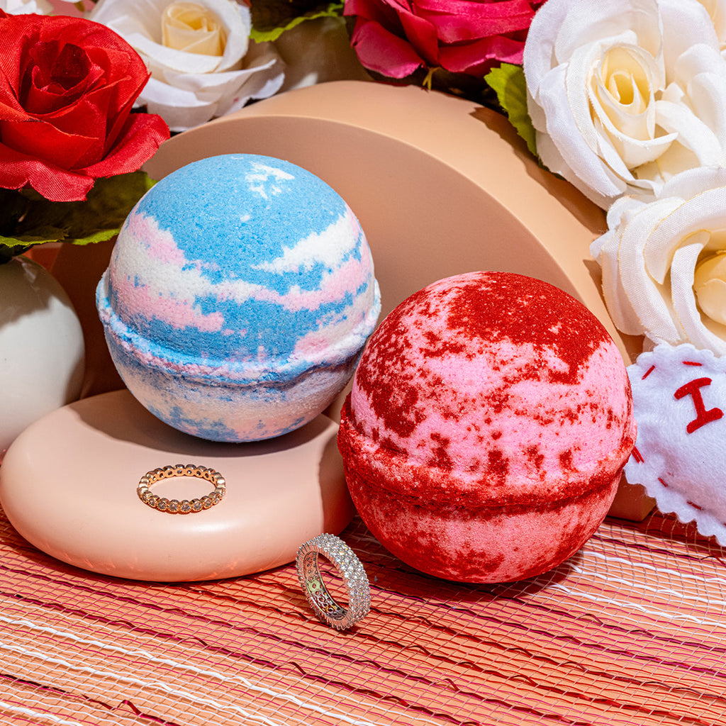 Blue and red speckled bath bombs with two jeweled rings