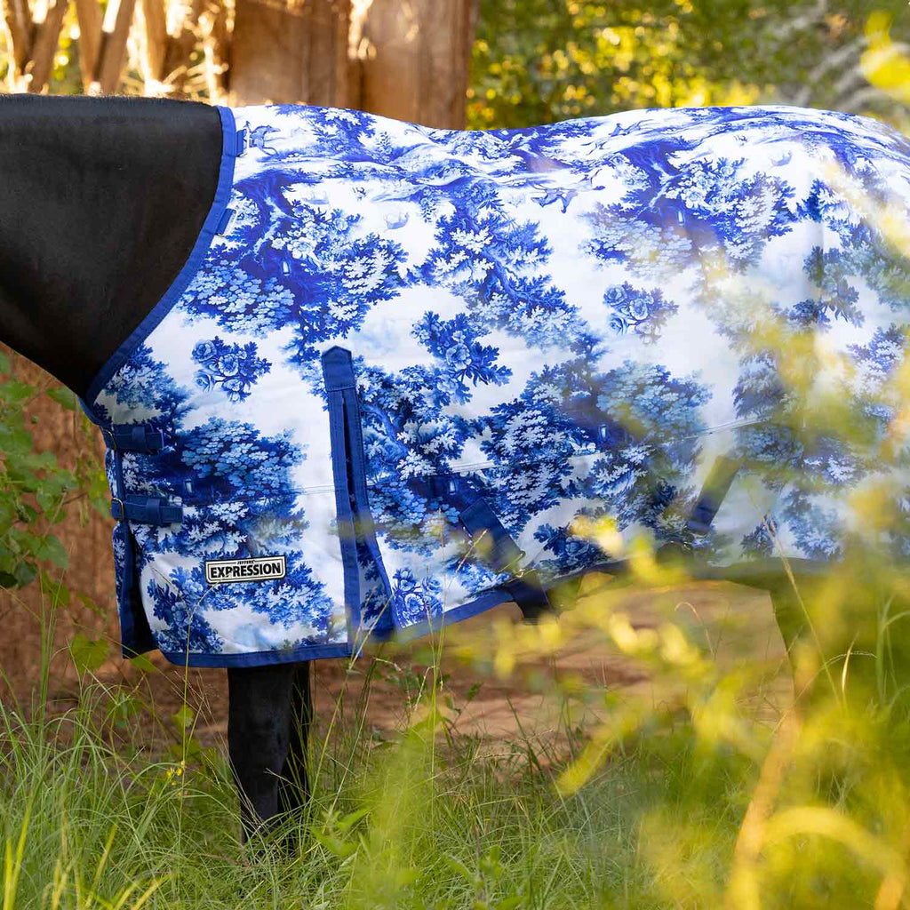 Horse turnout blanket in blue tree print with front strap panel and Expression logo