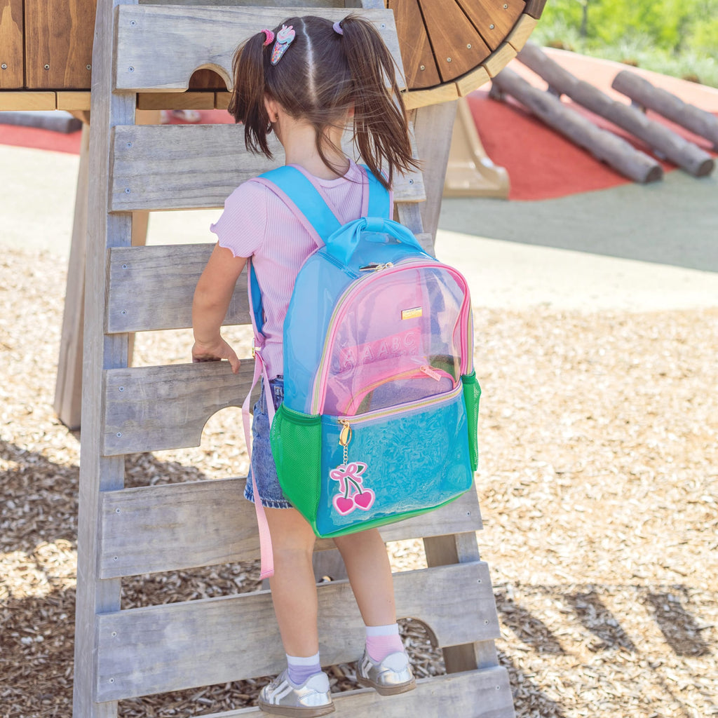 Clear jelly backpack in aqua and green with pink trim, worn by child
