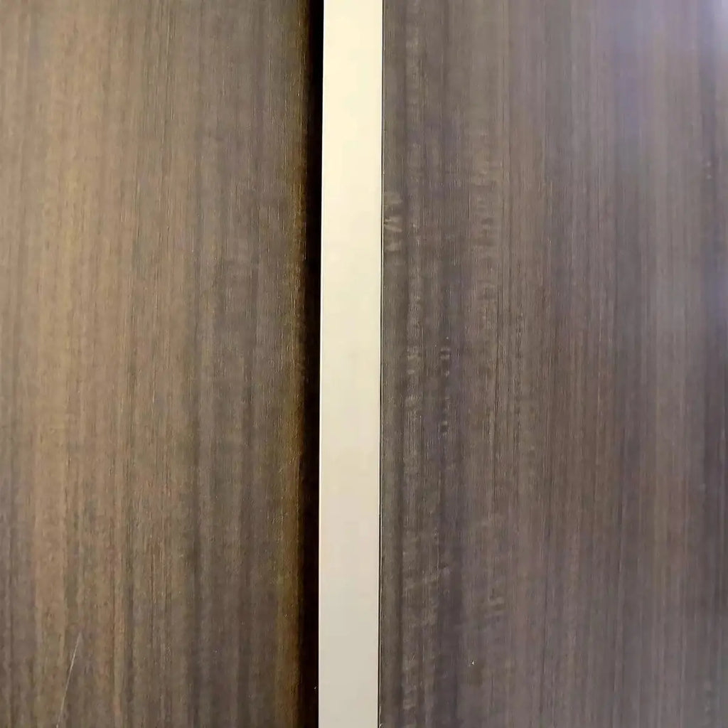 Oak brown woodgrain panel with light trim between cabinet sections