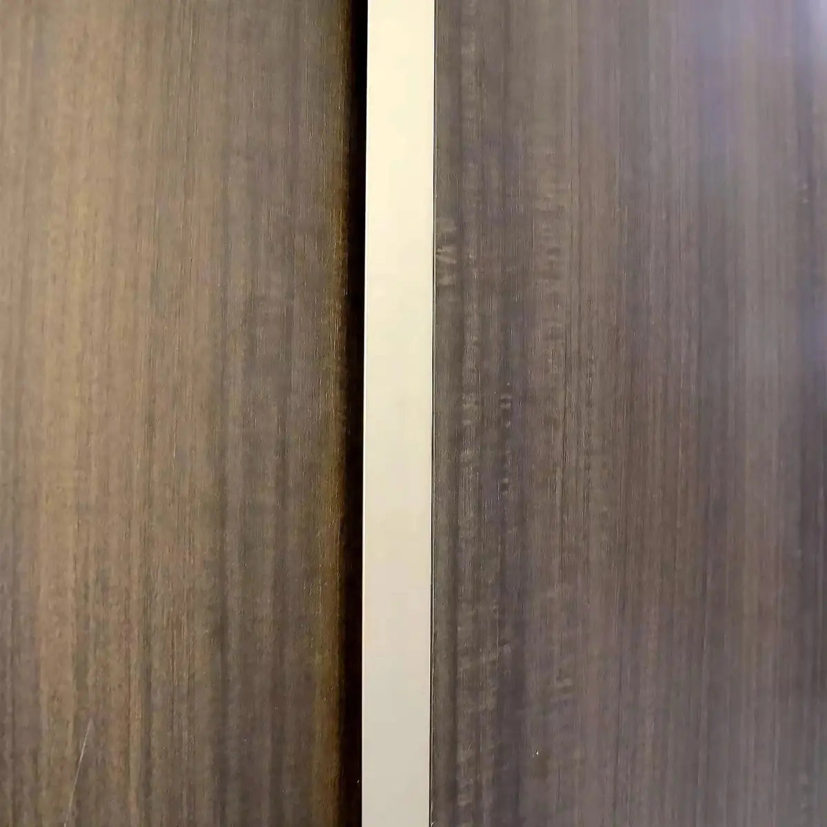 Oak brown woodgrain panel with light trim between cabinet sections