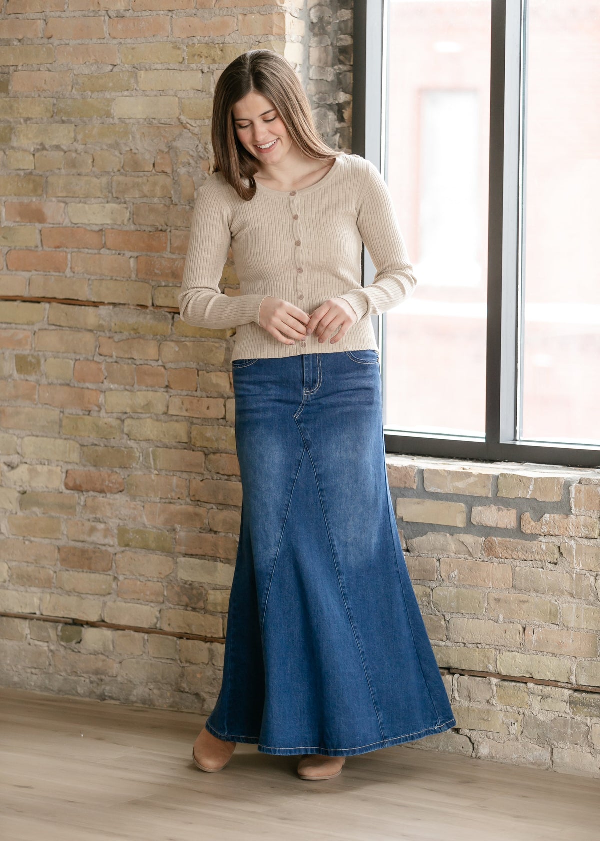 Long denim A-line skirt with front button closure and flared hem, medium blue wash