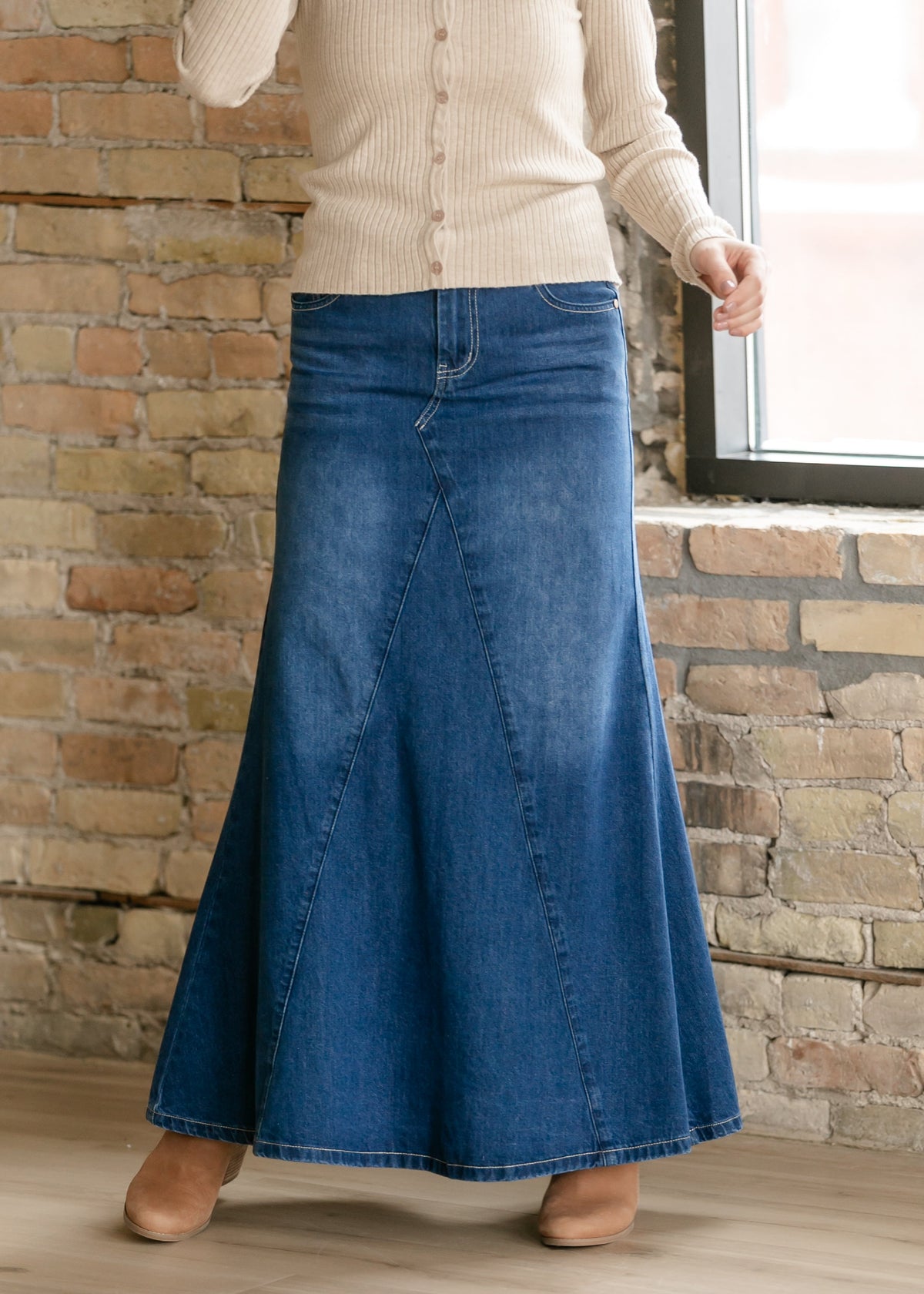 Long denim A-line skirt with front seam detail and flared hem, medium blue wash