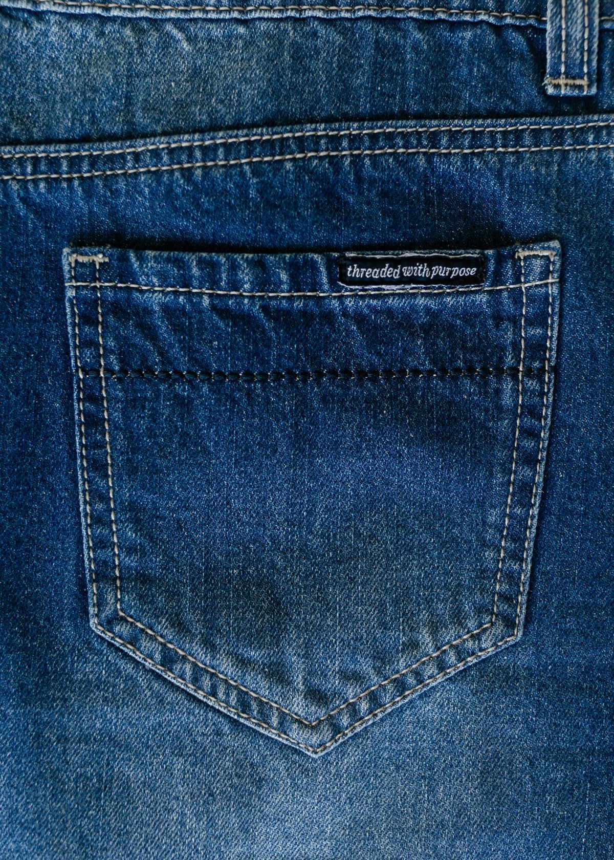 Denim patch pocket with stitched yoke detail on blue long A-line skirt