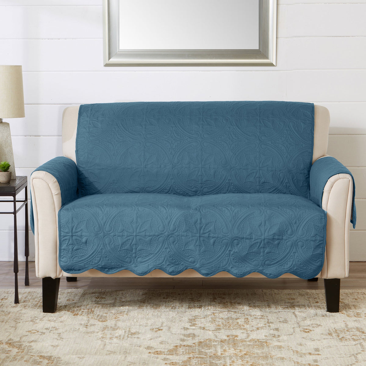 Blue quilted recliner furniture protector with beige arms and seat cover
