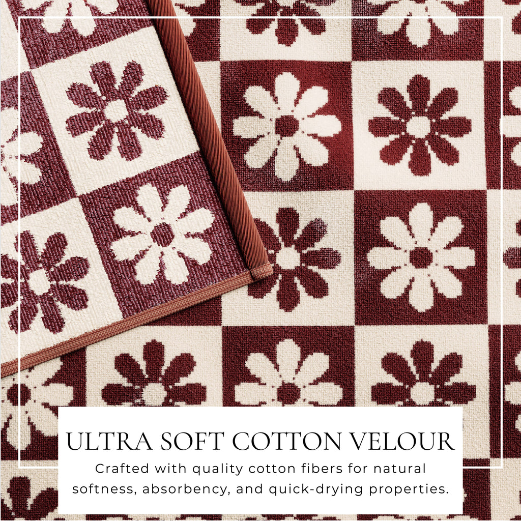 Cotton velour beach towel with maroon and white flower pattern, bordered.