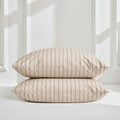 Beige sateen pillowcases with thin gray vertical stripes and envelope closure
