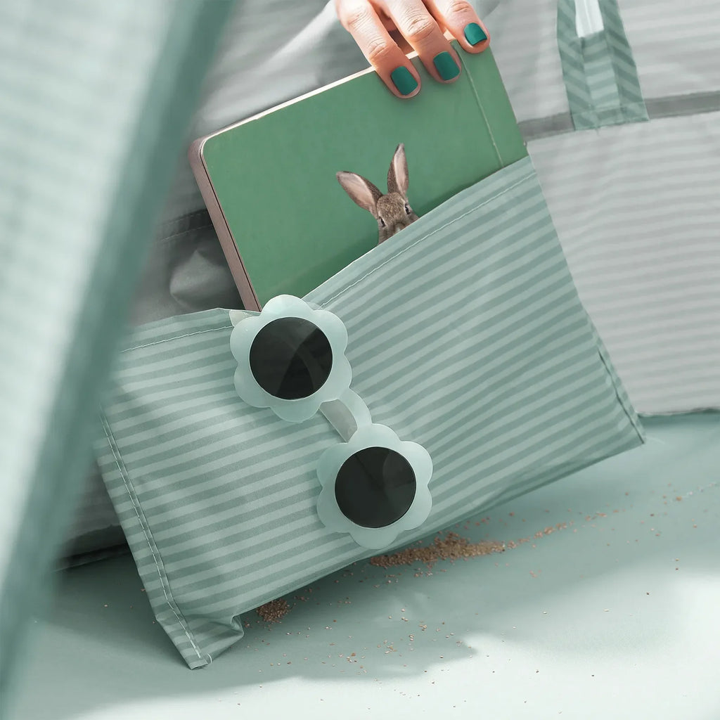 Green striped baby beach tent front pocket with hanging toiletry accessory and bunny toys