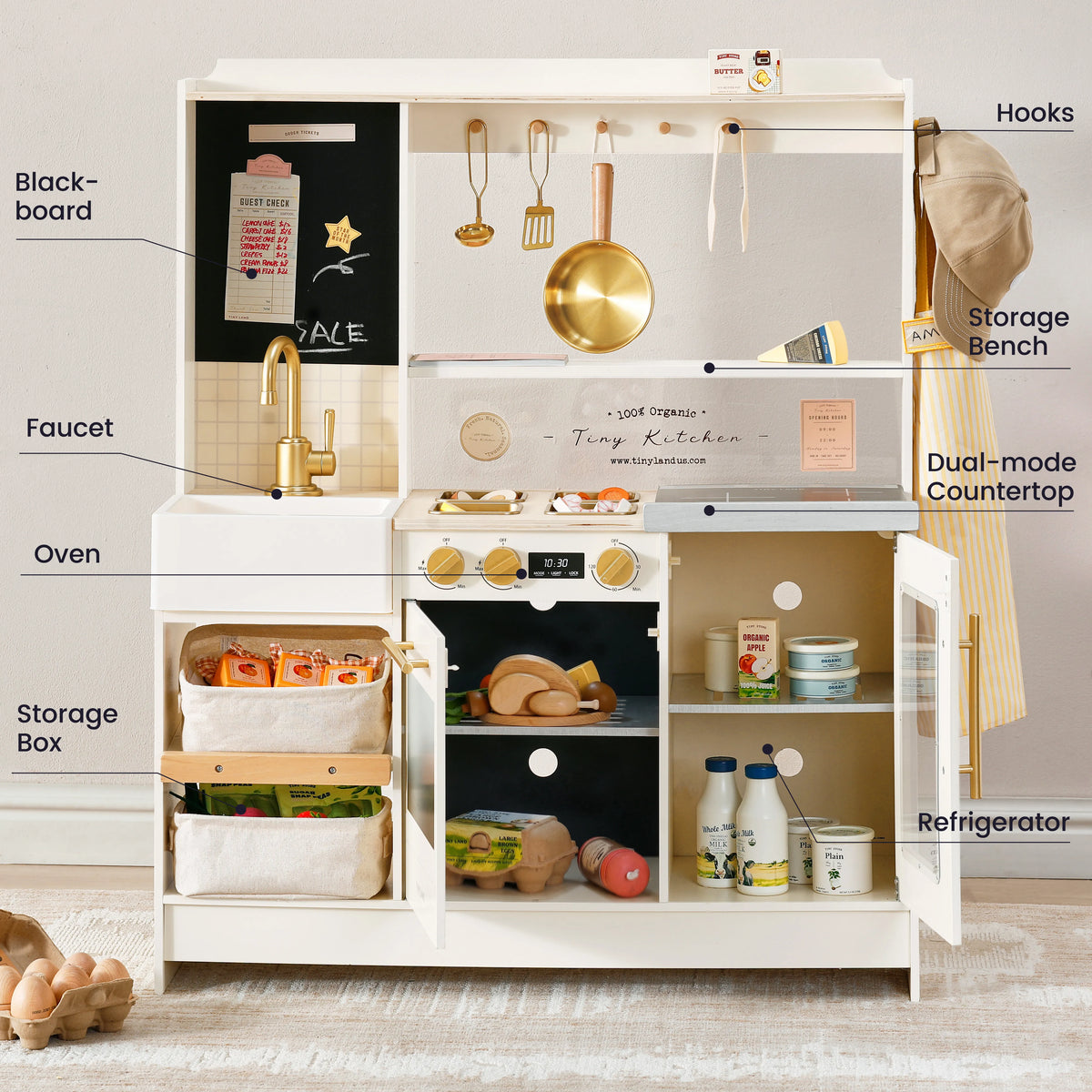 Open play kitchen toy showing blackboard, sink, oven, storage box, and fridge