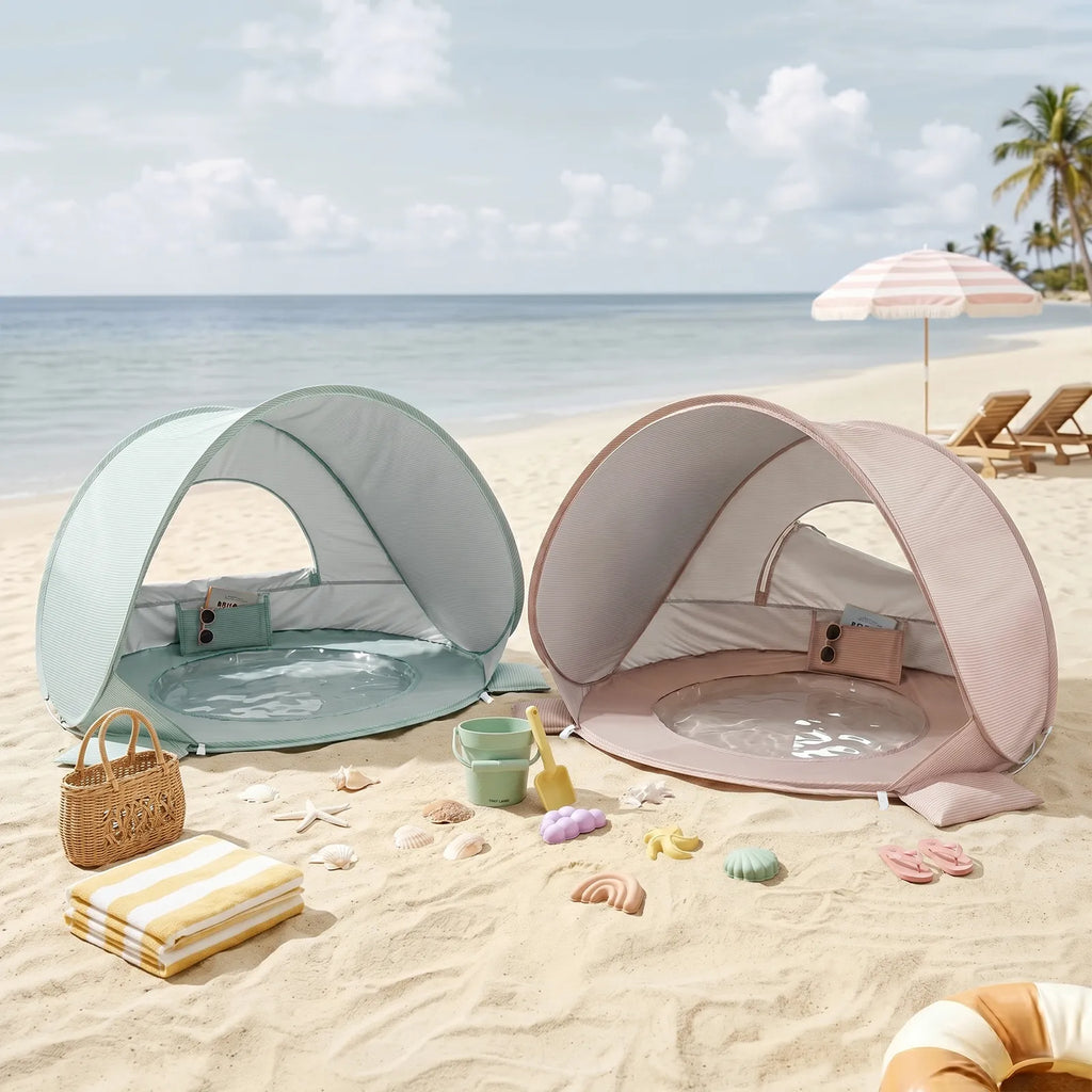 Two baby beach tents in green and pink with arched openings on sand