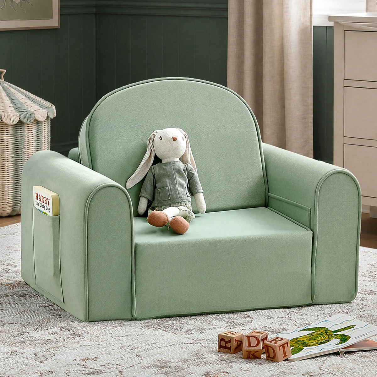 Light green kids sofa chair with rounded arms and cushioned seat