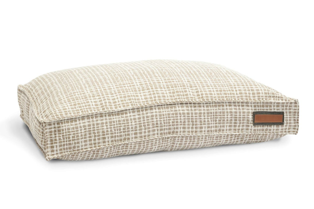 Round pet bed with light woven plaid cover and padded bolstered edge