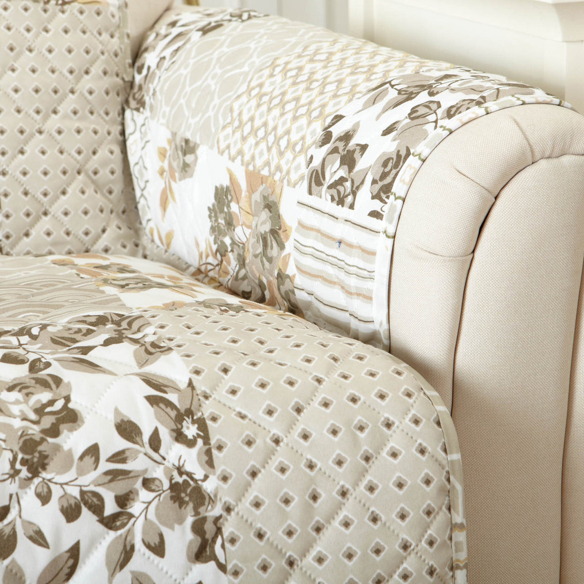 Reversible armchair protector showing taupe floral and textured diamond fabric panels