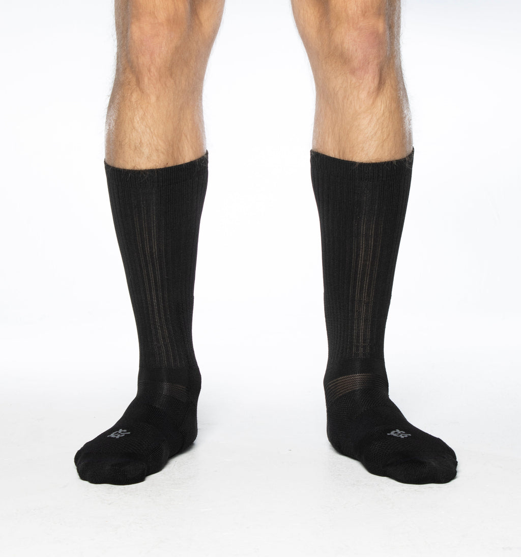 Black crew socks worn on feet with cushioned black toe