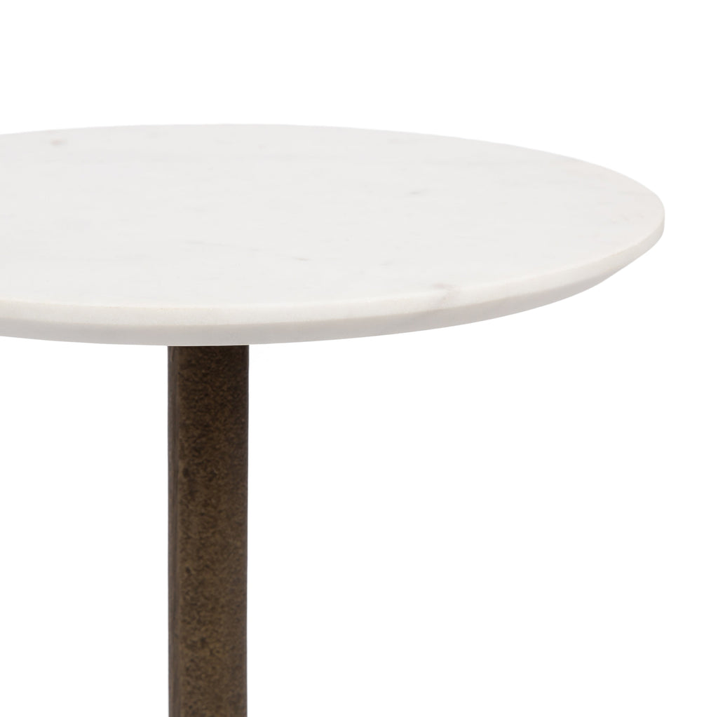 Close-up of white marble tabletop on a bronze pedestal side table