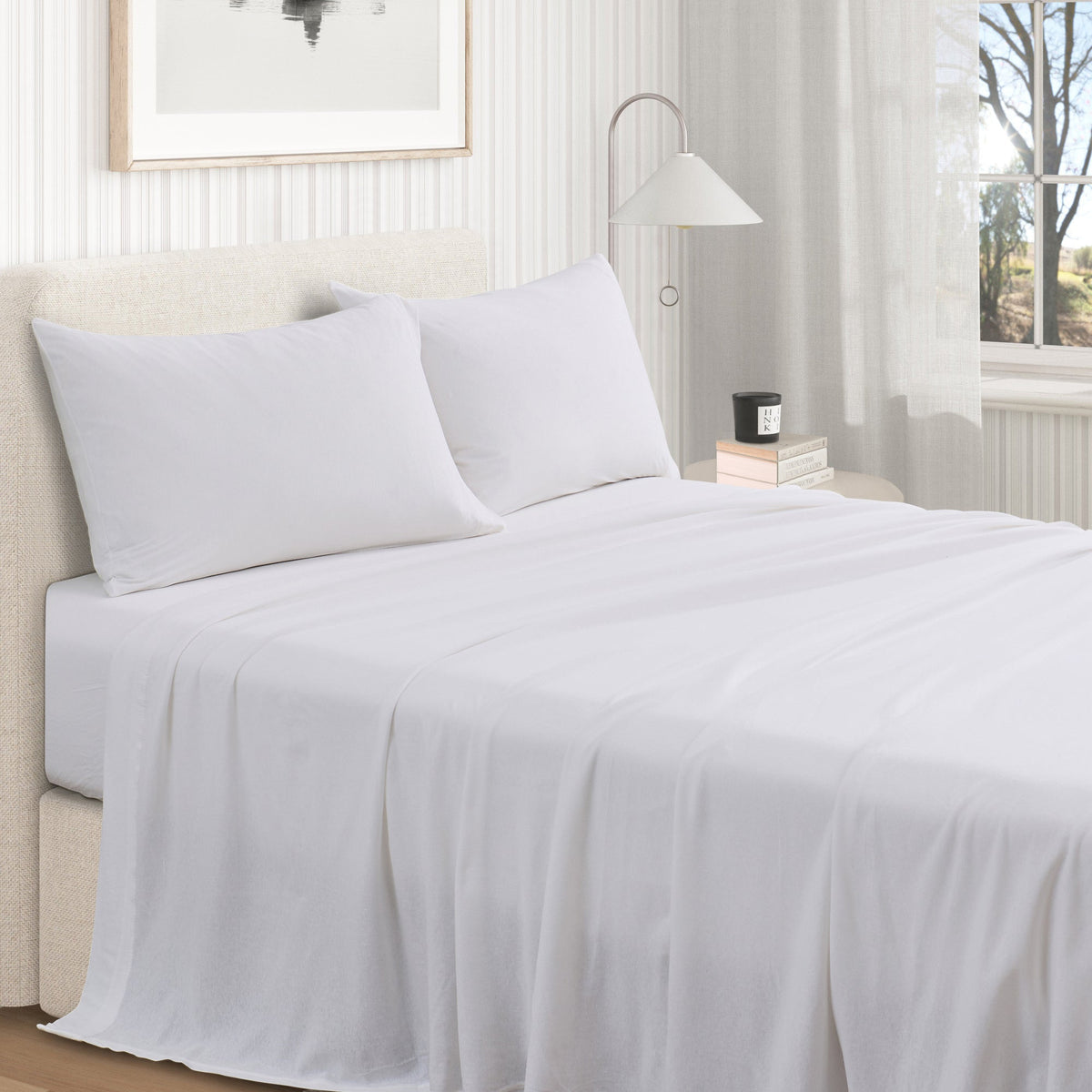 White jersey knit sheet set on bed with two pillowcases