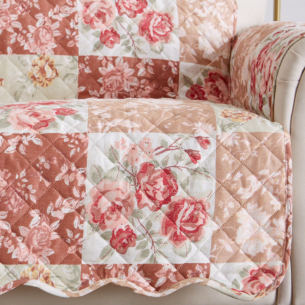 Quilted floral patchwork loveseat protector with red blooms and geometric blocks