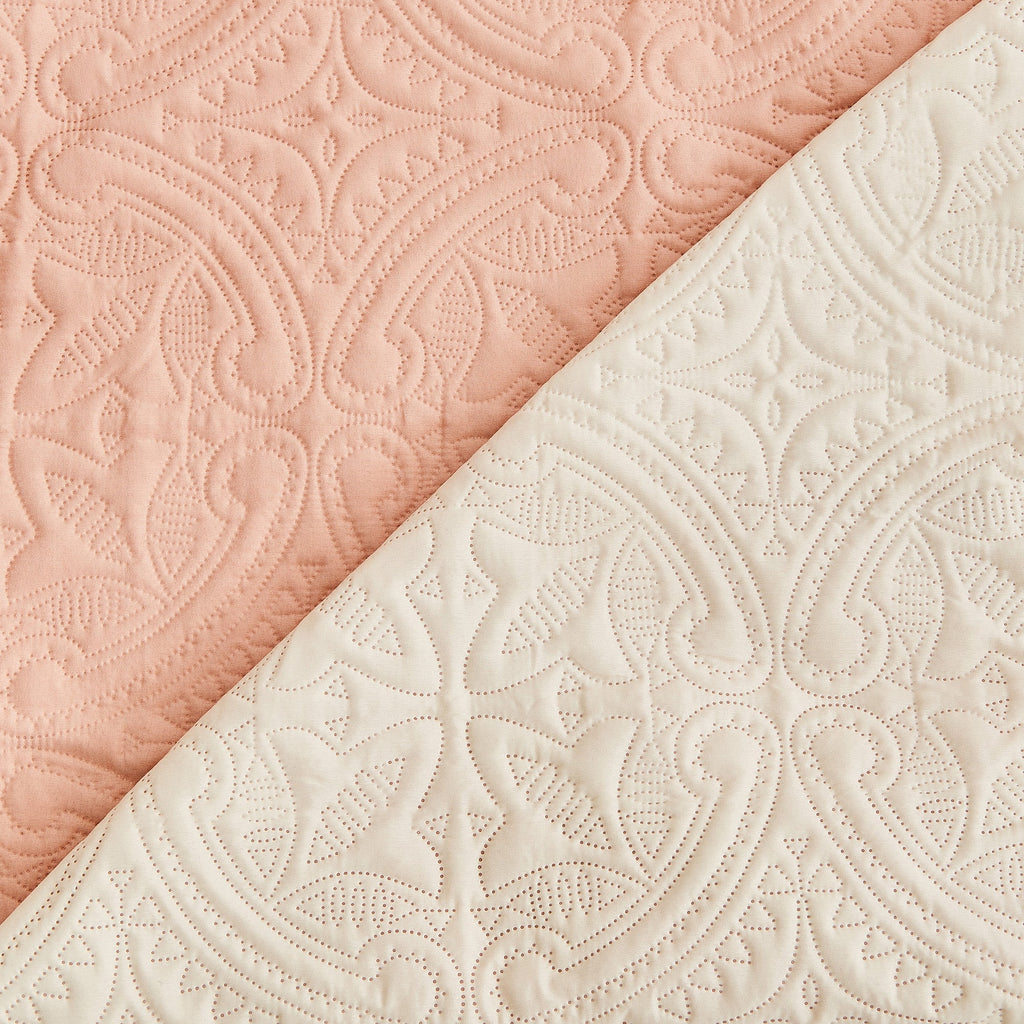 Medallion-quilted protector fabric panel in dusty rose and ivory, textured pattern
