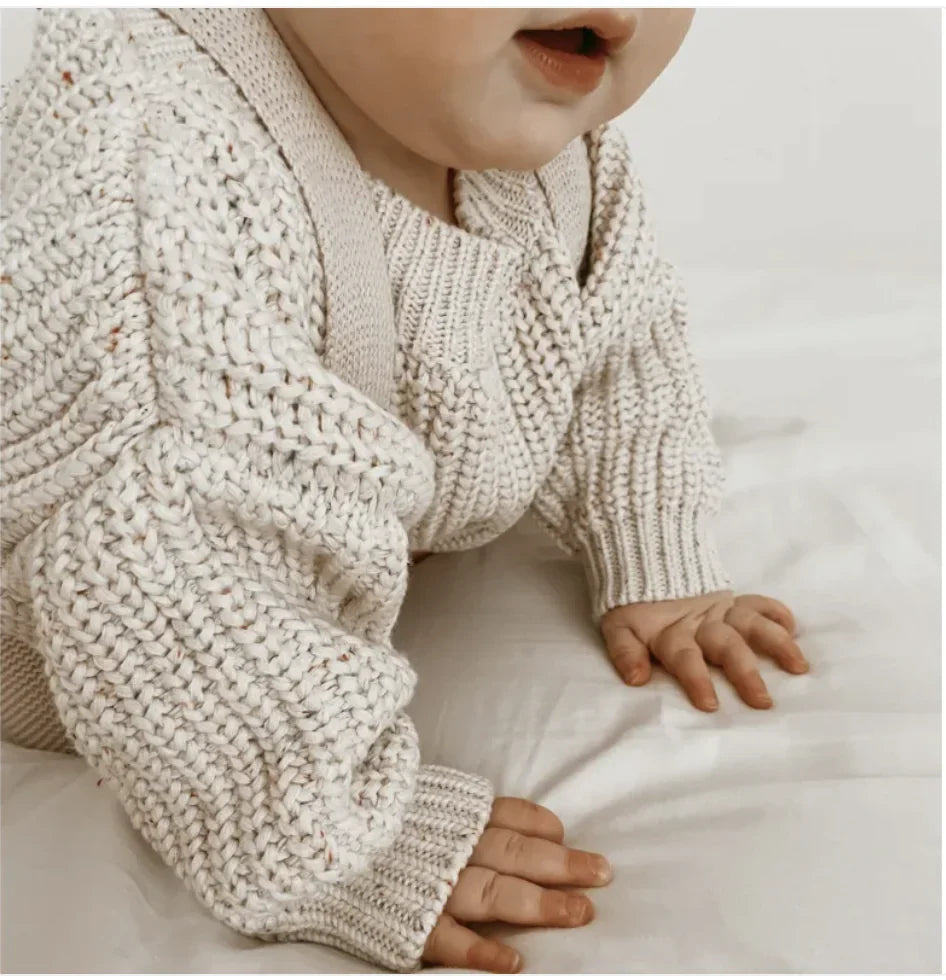 Kids' cotton long-sleeve pullover sweater worn by child, speckled textured knit.