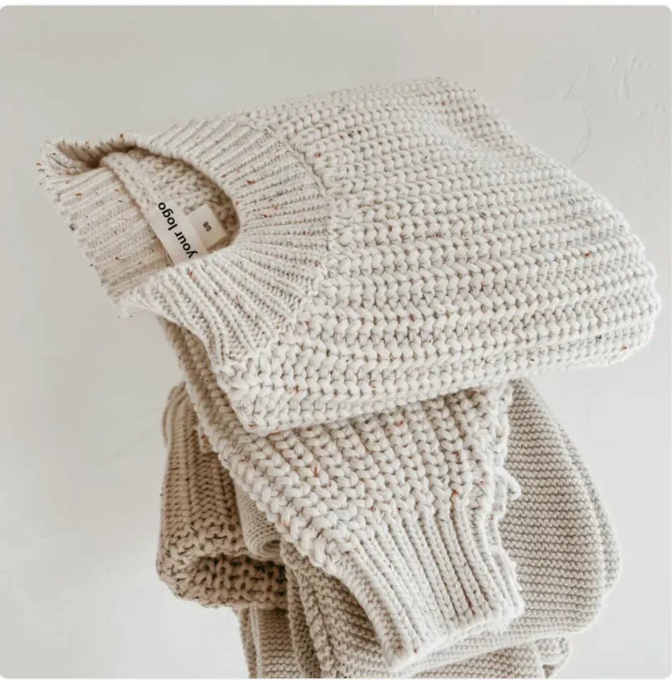 Kids' cotton long-sleeve pullover sweater with ribbed cuffs and small fabric label.