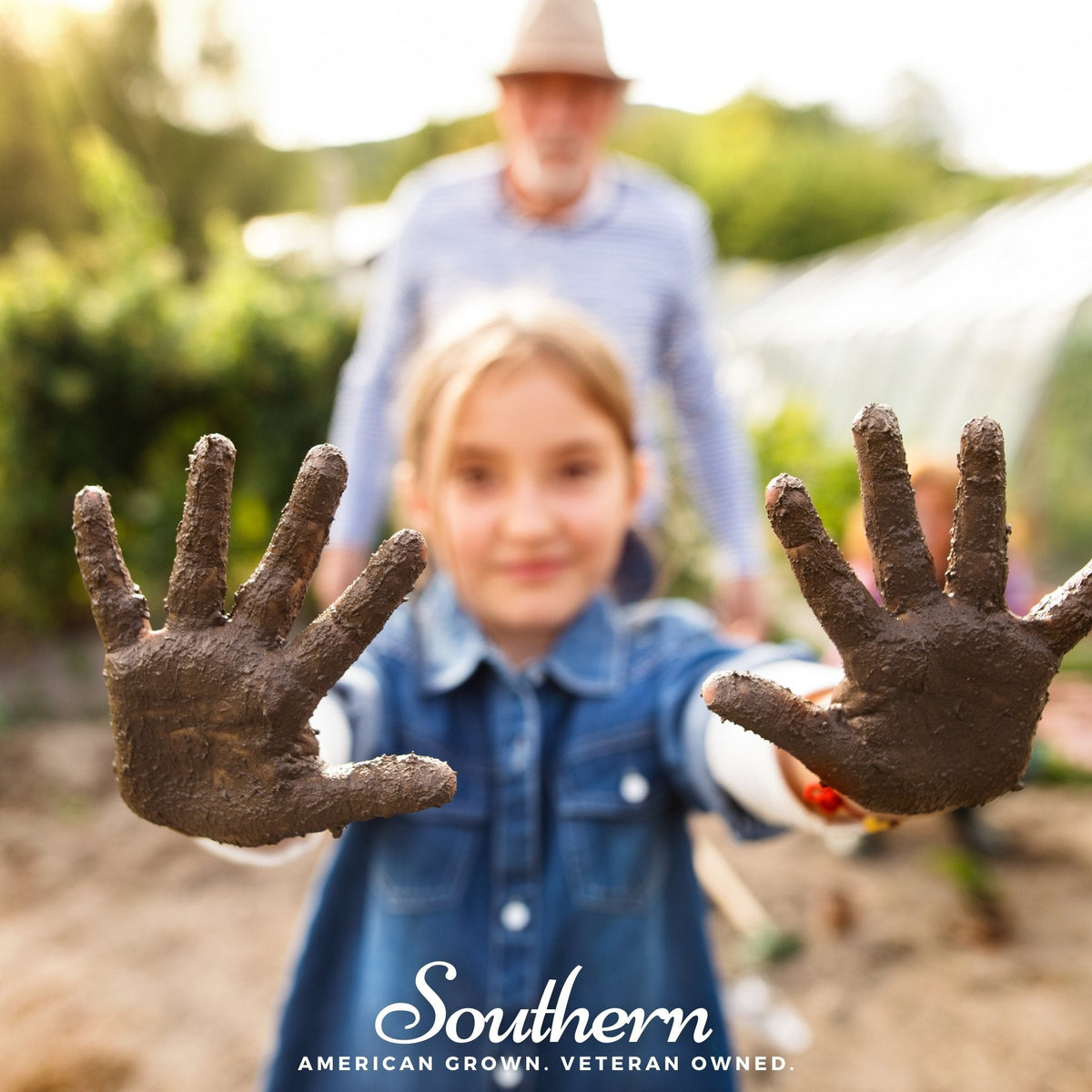 Kids gardening seed set, child holds muddy hands in outdoor garden