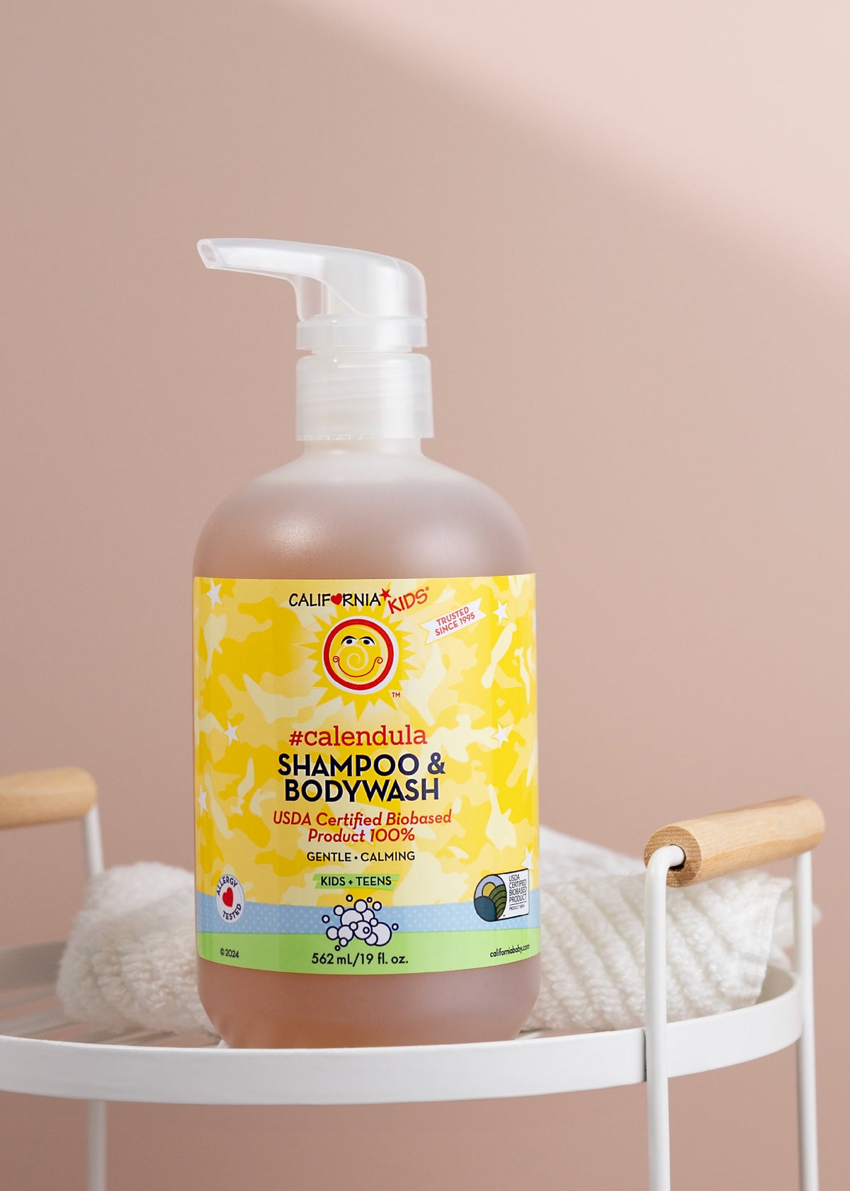 Kids Calendula shampoo & body wash bottle with white pump, amber liquid, yellow label