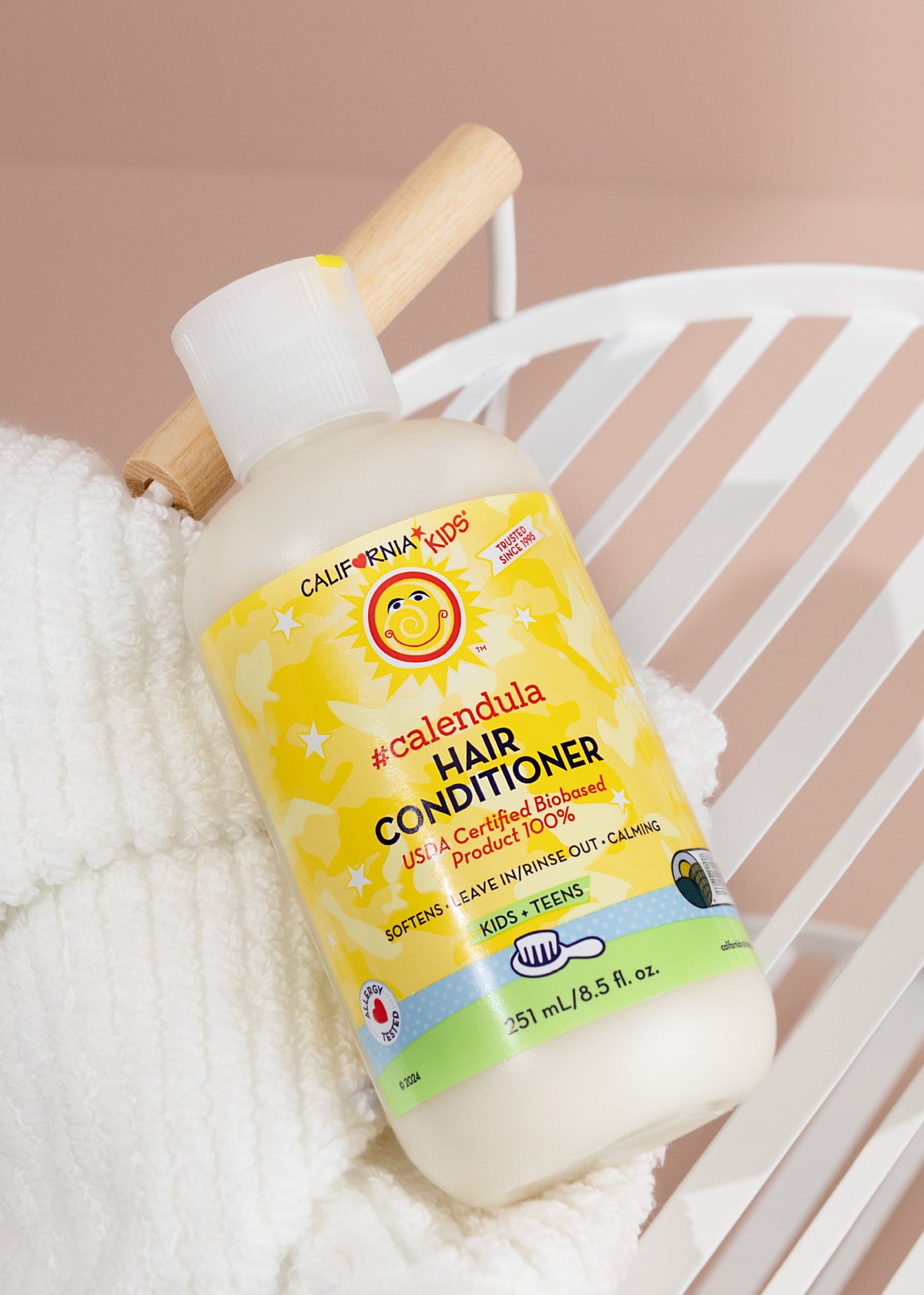 Kids Calendula hair conditioner bottle with wooden cap, yellow label, white body