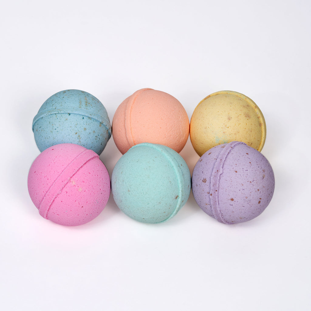 Six pastel bath bombs: blue, orange, yellow, pink, teal, and purple
