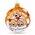 Glass ball Christmas ornament with two bears and 'Merry Christmas' on orange