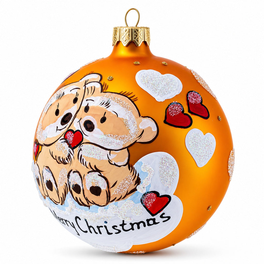 Glass ball Christmas ornament with glitter hearts and 'Merry Christmas' on orange